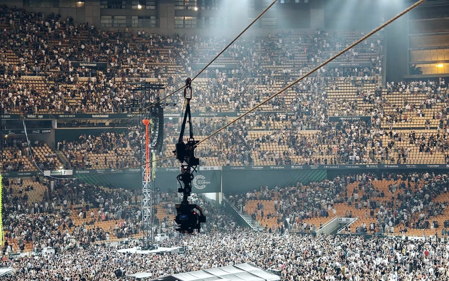 Linecam cablecam passing over the crowd during a concert in a stadium