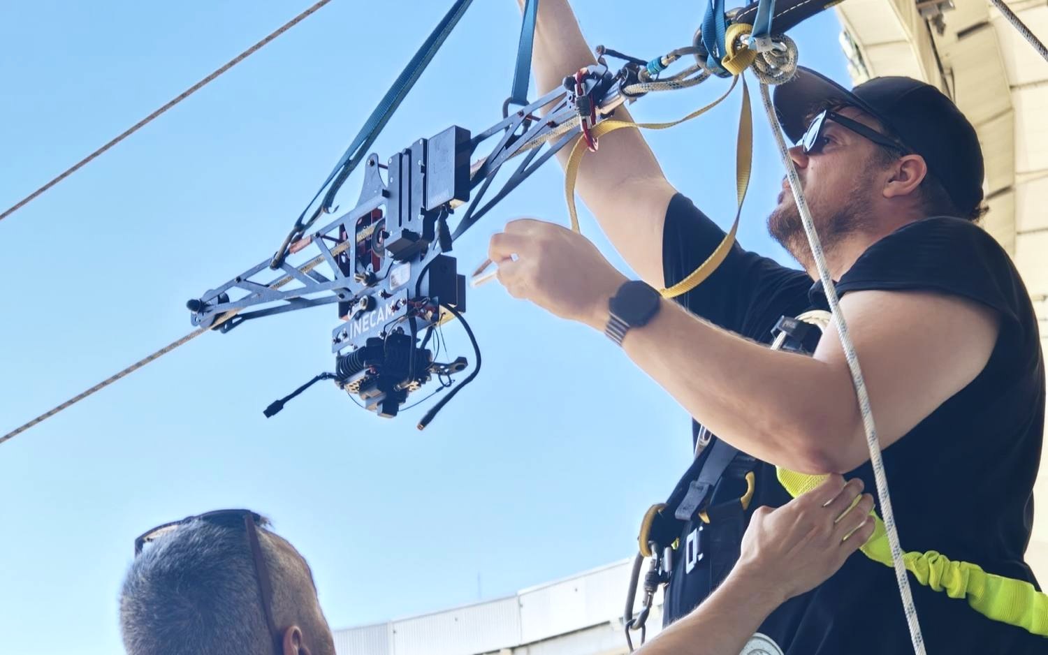 Linecam technical crew mounting the cablecam dolly on the line before the show